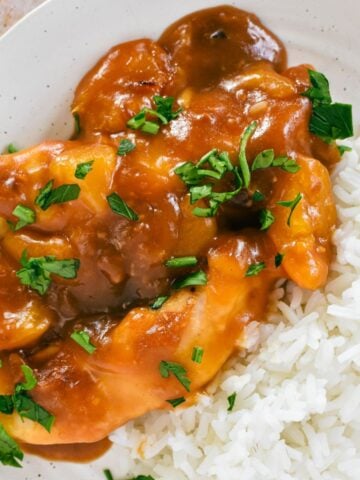 Apricot Chicken on plate with rice.