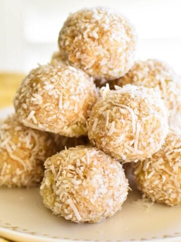 pineapple balls stacked on plate.