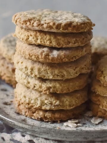 oatmeal biscuits stacked up on plate.