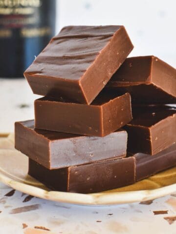 Bailey's Fudge squares piled on plate.
