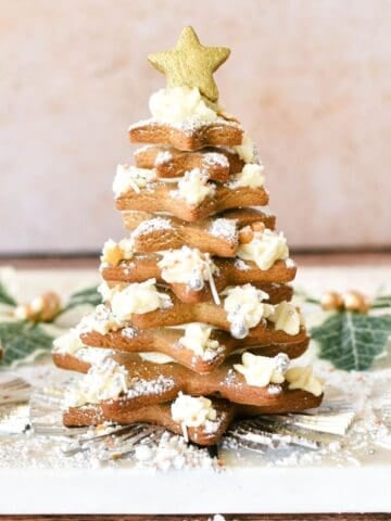 Golden star-shaped Christmas cookies decorated as a festive tree, perfect for holiday baking and dessert tables.