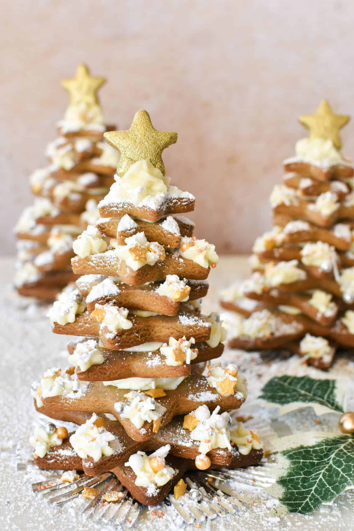 Golden star-shaped Gingerbread biscuits assembled and decorated as a festive Christmas tree.